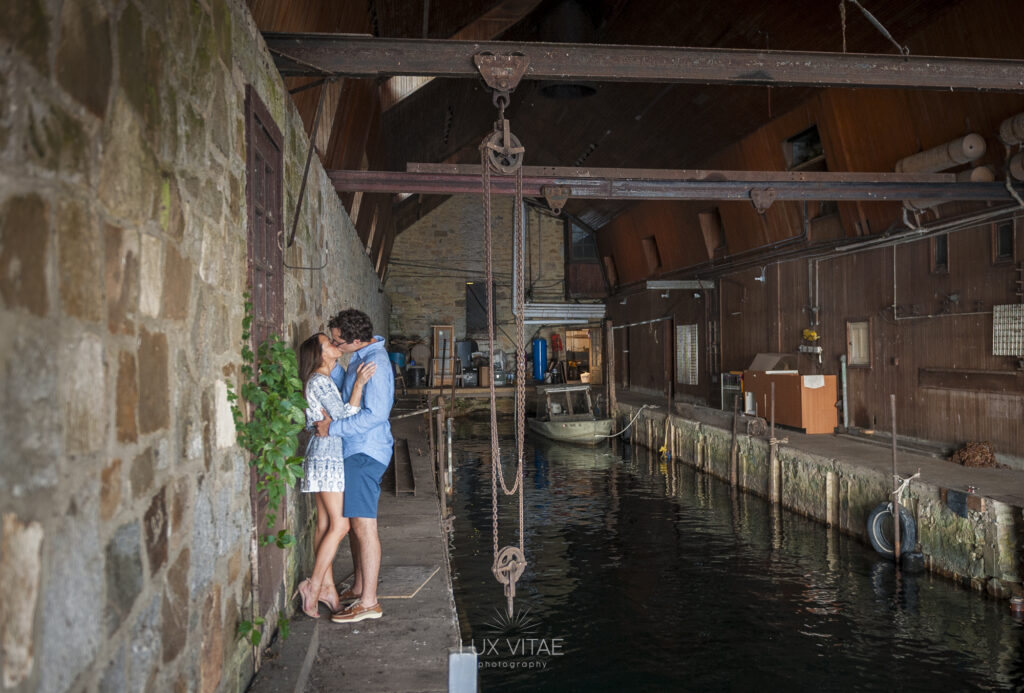 engagement session couple kissing in a castle on a river
