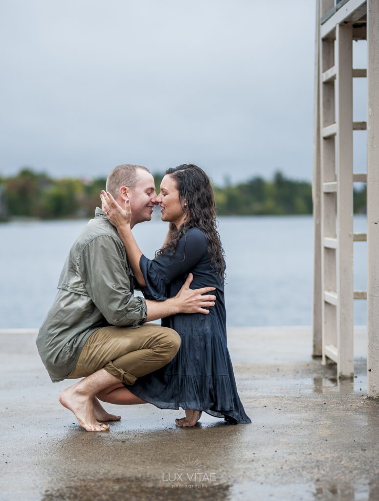 engagement session couple embracing by a river
